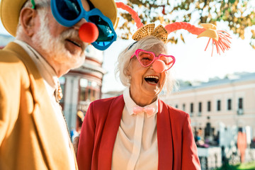 Beautiful elderly woman in a funny suit laughing