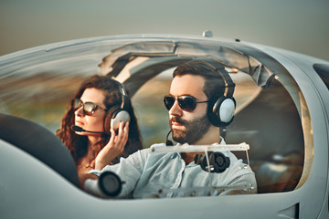 Young man and woman flying in private plane