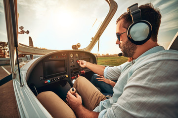 Serious man prepare take off on a sport airplane