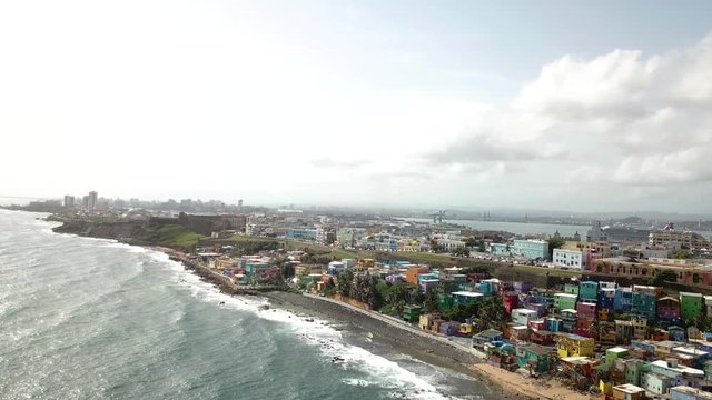 Drone Aerial View on San Juan Puerto Rico City Waterfront, Colorful Houses in La Perla District, Castilo De San Cristobal and Downtown Skyline