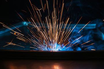 Industrial welding of iron construction. Process by manual welding. Splatter