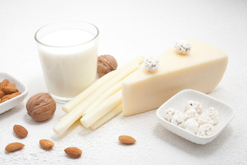 Types of cheese, hard, pigtail, sour milk, highlighted on a white background, there is a place for the inscription. The concept of types of cheese or dairy products containing calcium.