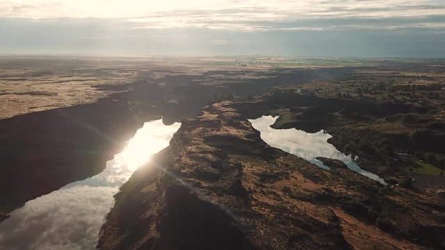Breathtaking Aerial View on Canyon of Snake River, Downstream of Shoshone Falls With Golden Hour Sunlight Reflection on Water Surface