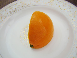 orange isolated On a white porcelain plate