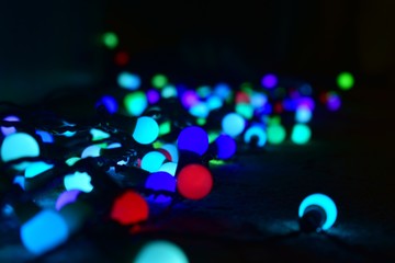 Clusters of colorful garlands in the dark.
