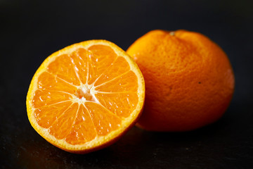 Orange fruit on black background 