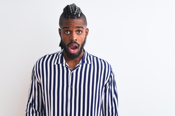 African american man with braids wearing striped shirt over isolated white background afraid and shocked with surprise expression, fear and excited face.