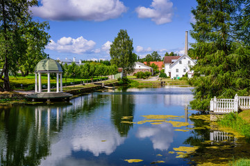 Fototapeta na wymiar Sightseeing of Estonia. Palmse manor (Palmse möis) museum in Lahemaa National Park. Beautiful summer landscape. A picturesque Park with a pond.