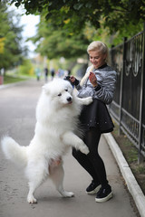 Lovely girl on a walk with a beautiful dog