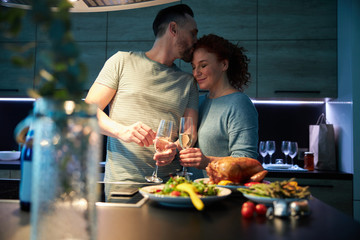 Couple in love celebrating with meal in kitchen stock photo