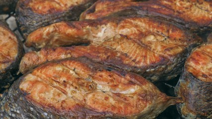 Obraz na płótnie Canvas Fried grilled salmon on bbq. Marinade from white sauce and lemon.