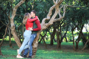 Naklejka na ściany i meble Beautiful young couple on date in the park