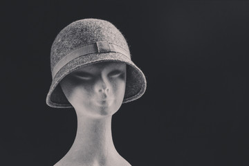 grey female hat on puppet head, space for text