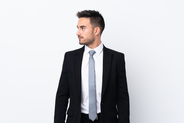Young business man over isolated background looking side