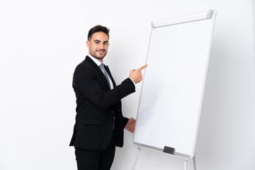 Young man giving a presentation on white board and writing in it