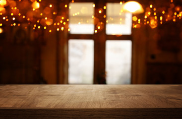 image of wooden table in front of abstract blurred window light background