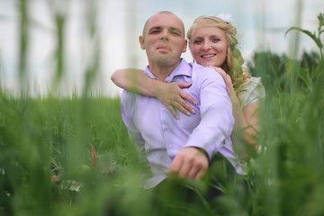 Couple lovers walking in field in summer day