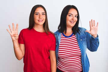 Young beautiful women wearing casual clothes standing over isolated white background showing and pointing up with fingers number nine while smiling confident and happy.