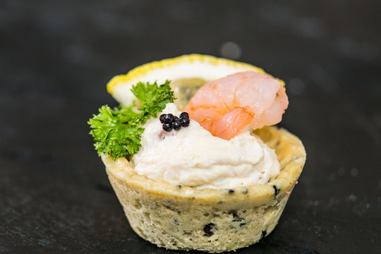 Detail of a canapes of a meal at an event, wedding, meeting or congress with food. Canapes decorated on the dish