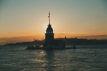 Silhouette of Maiden Tower and Istanbul during sunset golden hour with moody tone colors