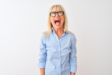 Middle age businesswoman wearing elegant shirt and glasses over isolated white background angry and mad screaming frustrated and furious, shouting with anger. Rage and aggressive concept.
