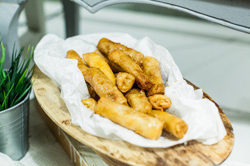 Tasty fried chicken strips with sesame, serving on event dish at party