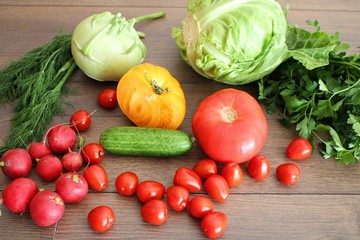 Tomatoes cucumbers cabbage radish dill and parsley on a table in the village