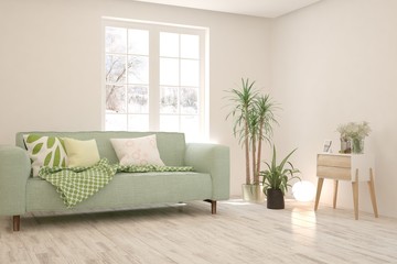 Stylish room in white color with sofa and winter landscape in window. Scandinavian interior design. 3D illustration