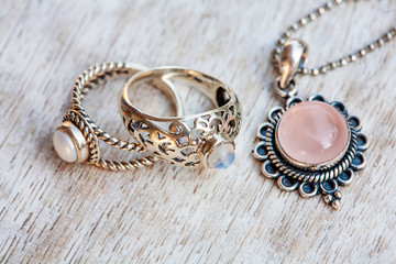 Silver jewelry on neutral bright wooden background