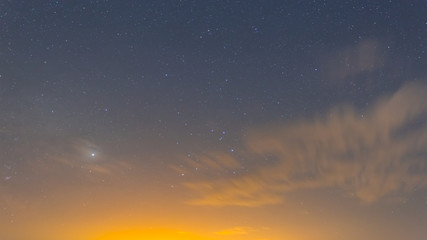 Fototapeta na wymiar night starry sky with milky way and clouds, natural dark sky background
