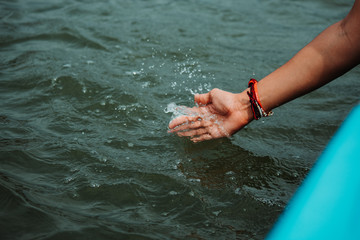 Closeup shot of hand in the water at Nakki Lake in Mount Abu, Rajasthan, India