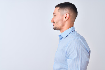 Young handsome business man standing over isolated background looking to side, relax profile pose...