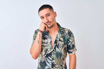 Young handsome man wearing Hawaiian summer shirt over isolated background thinking looking tired and bored with depression problems with crossed arms.