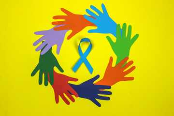Multicolored hands in a circle with a blue ribbon. Men's health and Prostate cancer awareness campaign concept. Symbol for support men who living with cancer. Copy space.
