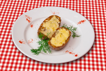 Stuffed baked potatoes with cheese served with green vegetables