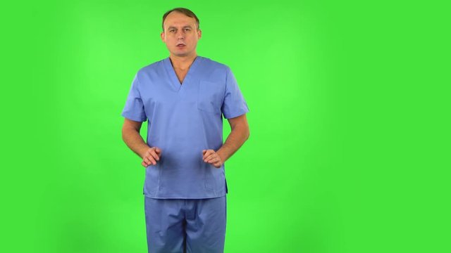 Medical man refuses stress and takes situation, calms down, breathes deeply. Green screen