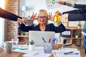 Group of business workers working together. Partners stressing one of them at the office