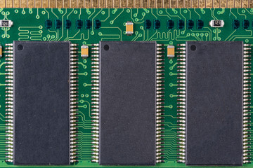 green microchip of old computer random access memory with black microcircuits, top view, macro photo