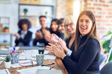 Group of business workers smiling happy and confident. Working together with smile on face looking at the camera applauding at the office
