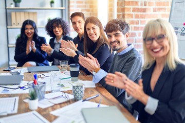 Group of business workers smiling happy and confident. Working together with smile on face looking at the camera applauding at the office