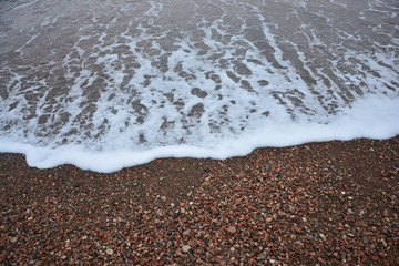 sea wave rolling on the shore the view from the top