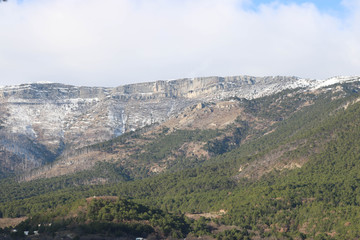 Fototapeta na wymiar green mountains with snow blue sky