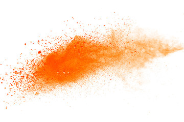 Abstract orange powder explosion. Closeup of orange dust particle splash isolated on white background.