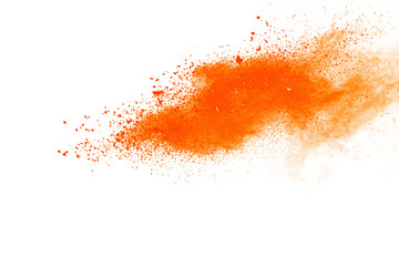 Abstract orange powder explosion. Closeup of orange dust particle splash isolated on white background.