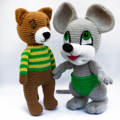 Amigurumi dolls cat mouse and dog is photographed on a white background.