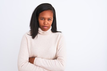 Beautiful young african american woman wearing turtleneck sweater over isolated background skeptic and nervous, disapproving expression on face with crossed arms. Negative person.