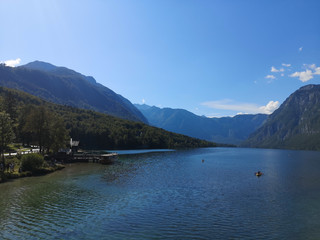 Fototapeta na wymiar Beautiful view of the crystal clear Bohinj lake from the water with the mountains in the background