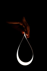 Flexible lighting oled panels in male hands on a black background