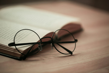 round glasses on a book