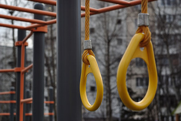 yellow gymnastic rings on the gym floor